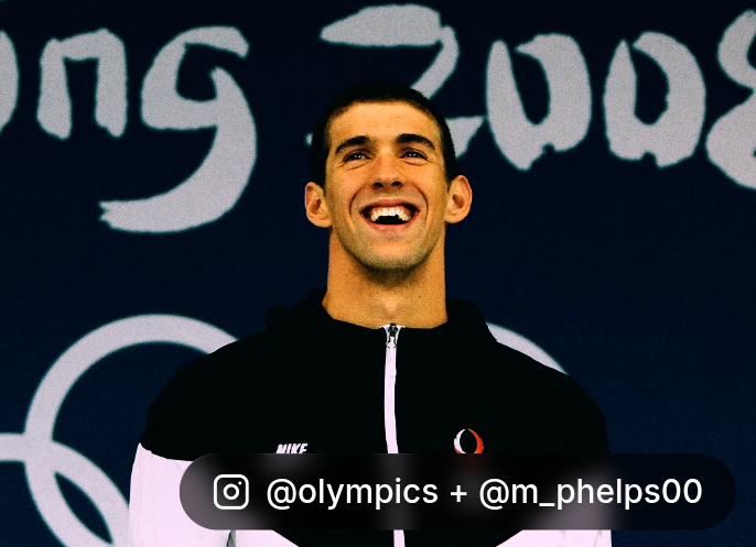 Michael Phelps smiling in front of the pool