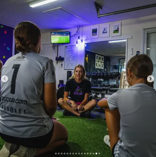 Erica Mulholland coaching young female athletes
