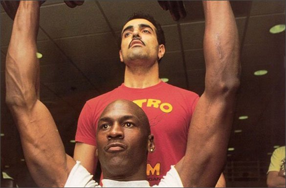 Tim Grover spotting Michael Jordan during an overhead lift