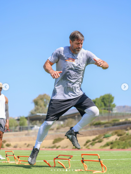 Aaron Rodgers running through agility hurdles on the field