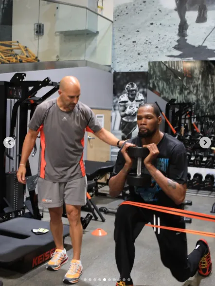 Ryan Capretta coaching Kevin Durant through a dumbbell lunge