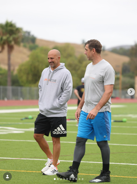 Ryan Capretta walking the field with Aaron Rodgers